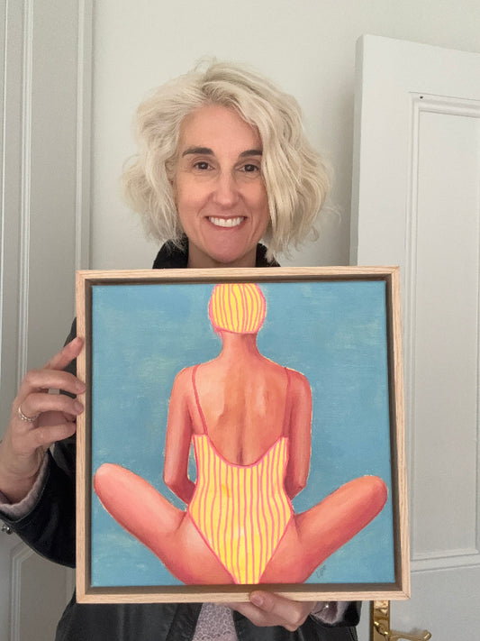 Artist Leah Mariani holding Centre Back small painting of swimmer