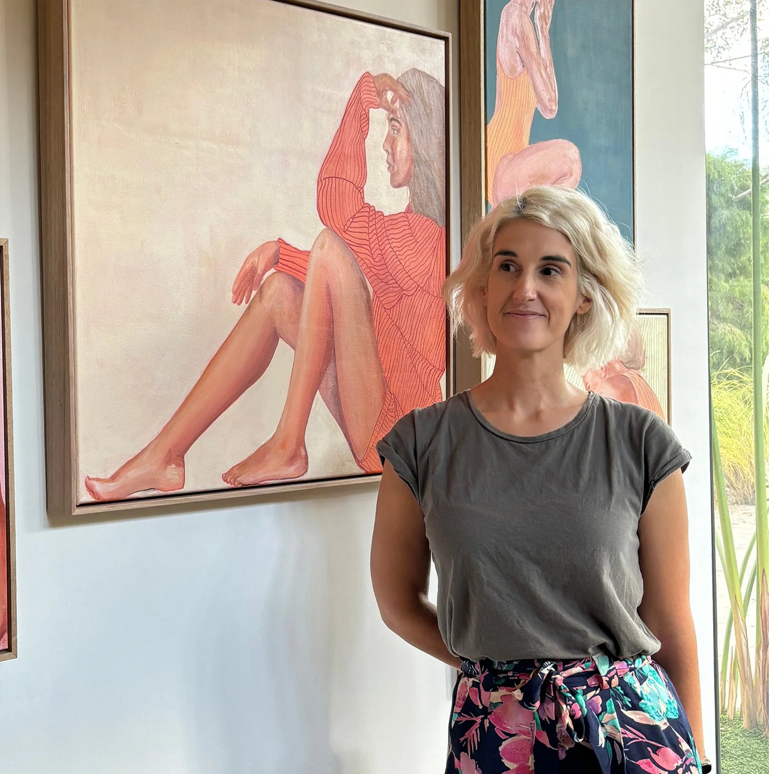 Artist Leah Mariani with paintings