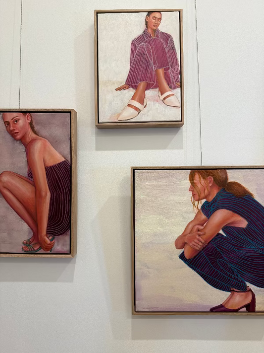 Cross court maroon painting hanging in art studio