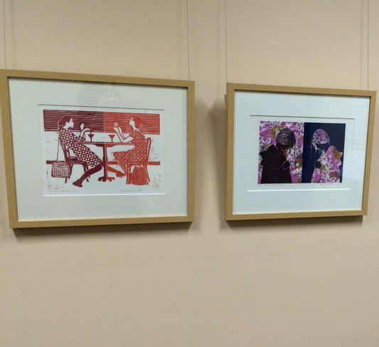 The Cocktail Hour framed linoprint hanging with another print by artist Leah mariani