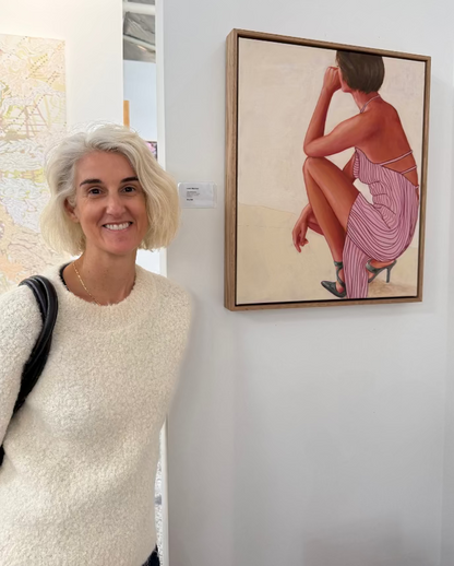 Artist Leah Mariani with leaderboard painting in gallery