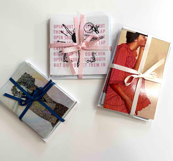 |Contained| greeting cards tied in ribbon